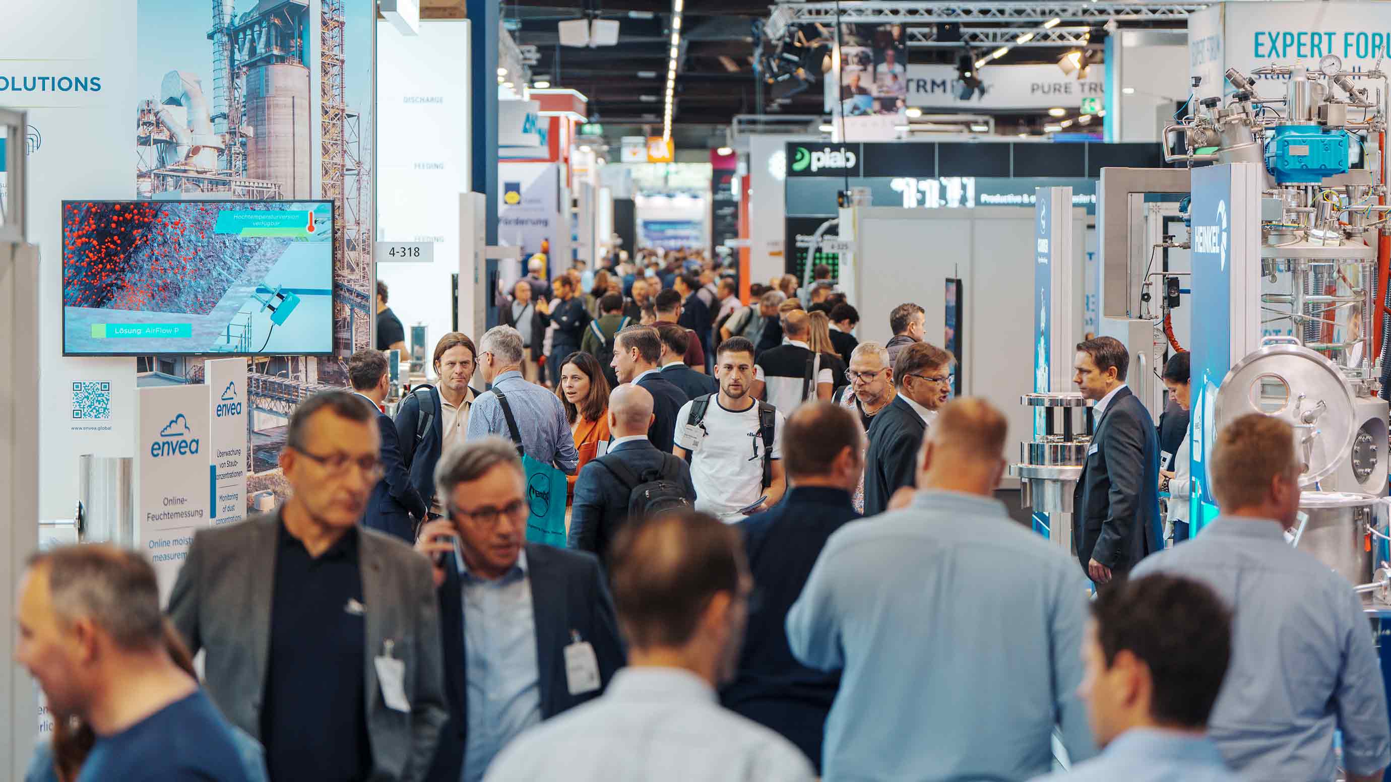 Visitors walk through the aisles at POWTECH